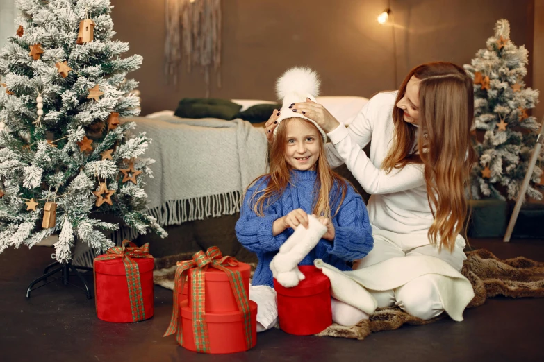 a woman combing a little girl's hair in front of a christmas tree, a portrait, by Emma Andijewska, shutterstock, birthday wrapped presents, square, 4 k image, 🎀 🍓 🧚