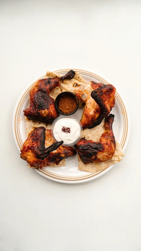 a white plate topped with chicken wings and dipping sauce, by Carey Morris, hurufiyya, smokey burnt envelopes, rotated left right front back, media photo, 15081959 21121991 01012000 4k