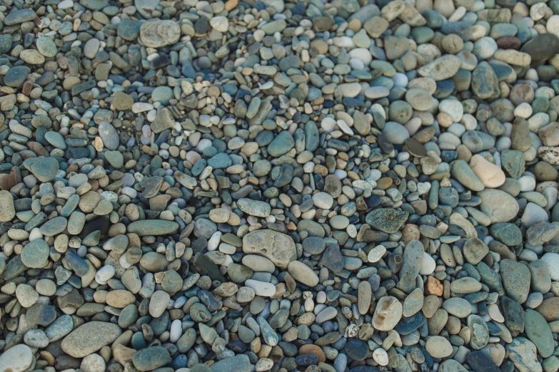 a close up of a pile of rocks and gravel, a mosaic, by Maksimilijan Vanka, unsplash, photo-realistic maximum detail, rocky seashore, street of teal stone, smooth tiny details