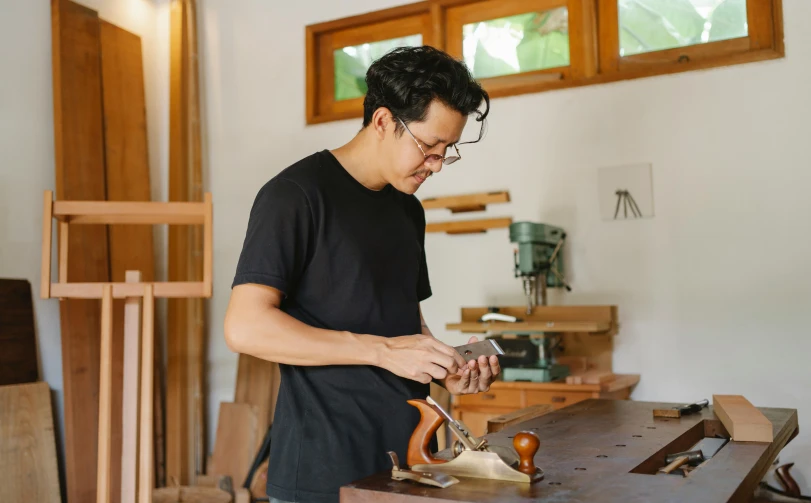 a man is working on a piece of wood, pexels contest winner, shin hanga, avatar image, asian male, profile image, 1 2 9 7