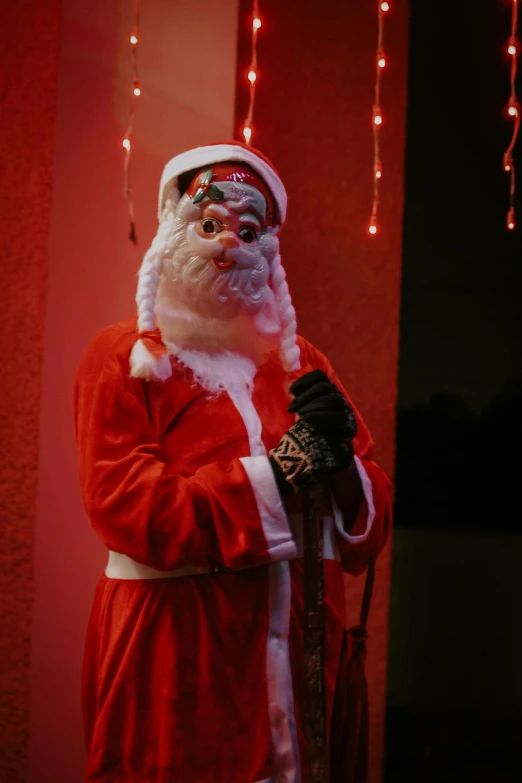 a man dressed as santa claus standing in front of a red wall, reddit, happening, scary stories, ( ( theatrical ) ), 15081959 21121991 01012000 4k