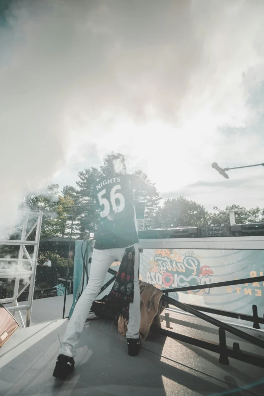 a man riding a skateboard up the side of a ramp, by Robbie Trevino, trending on unsplash, graffiti, in clouds of smoke, boston celtics, next to an rv, pictured from the shoulders up