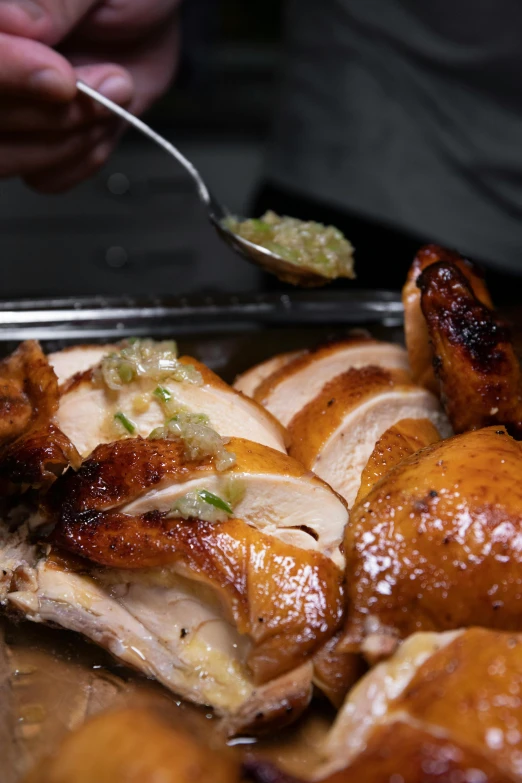 a close up of a tray of food on a table, chicken, thumbnail, piping, lit from the side