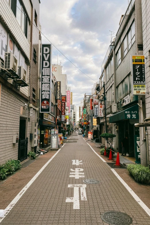 a city street filled with lots of tall buildings, a picture, unsplash, ukiyo-e, street signs, cobblestone streets, image, square