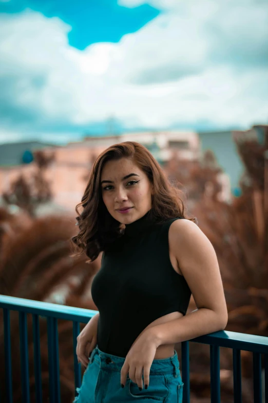 a woman standing on a balcony looking at the camera, a portrait, pexels contest winner, isabela moner, avatar image, large)}], outdoor photo