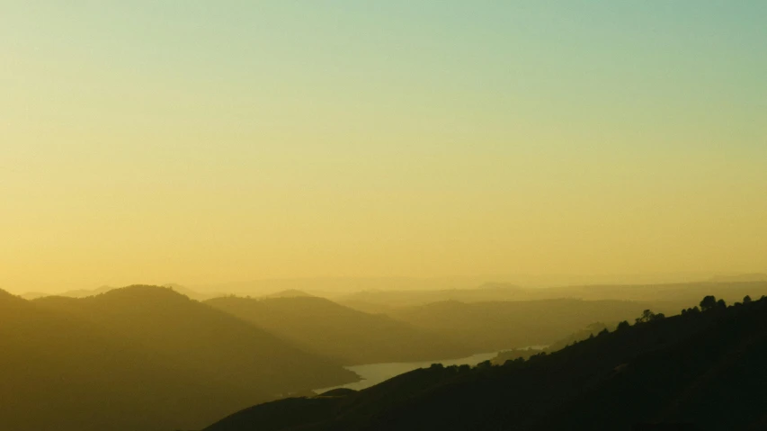 a person flying a kite on top of a mountain, inspired by Russell Chatham, pexels contest winner, tonalism, bay area, yellow sky, view, napa