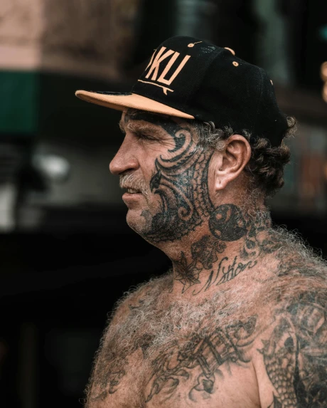 a man with a lot of tattoos on his chest, by Drew Tucker, trending on unsplash, wearing a white bathing cap, new zealand, prideful look, thick black lines