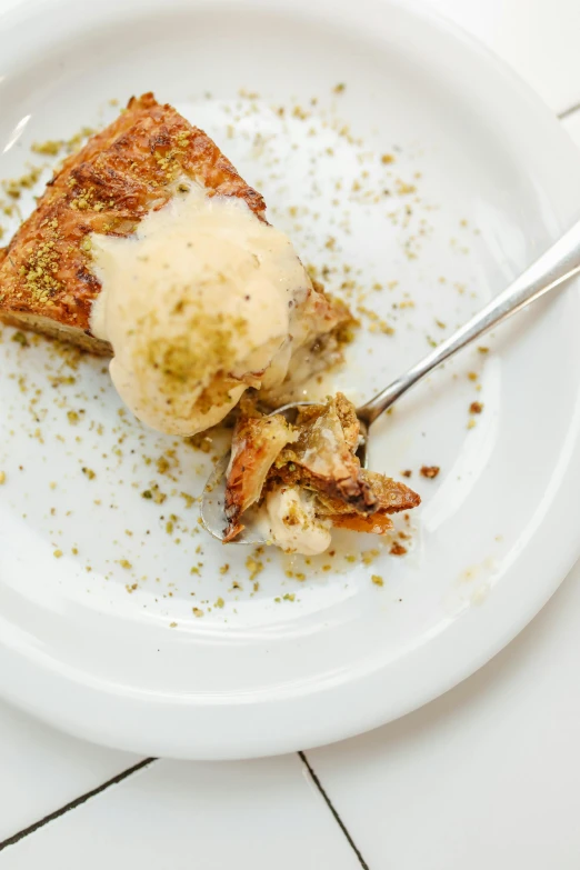 a white plate topped with a piece of cake, inspired by Géza Dósa, unsplash, renaissance, ice cream on the side, toast, middle eastern, 2 5 6 x 2 5 6 pixels