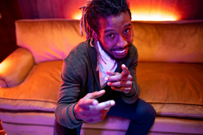 a man sitting on a couch playing a video game, an album cover, by Edwin Georgi, pexels contest winner, lil uzi vert, portrait pose, square, felix englund