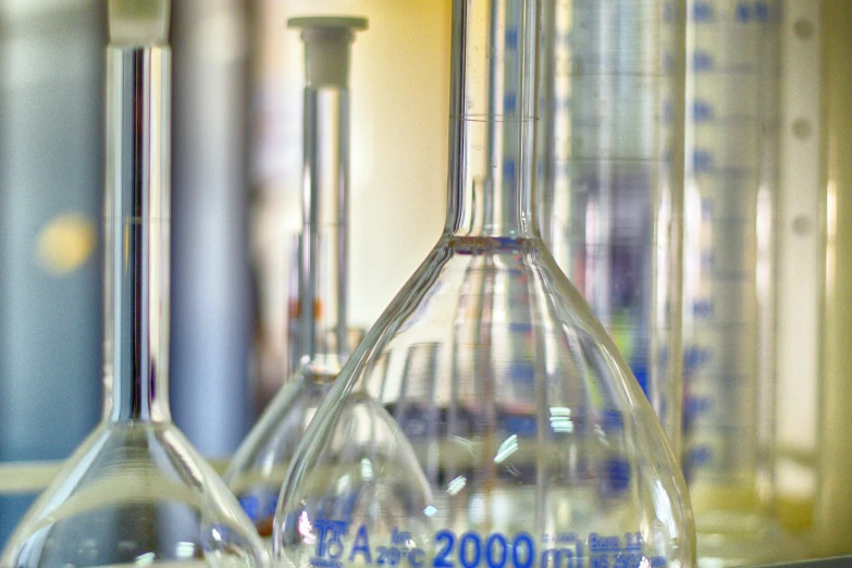 a group of glassware sitting on top of a counter, a picture, in a lab, up-close, illustration »