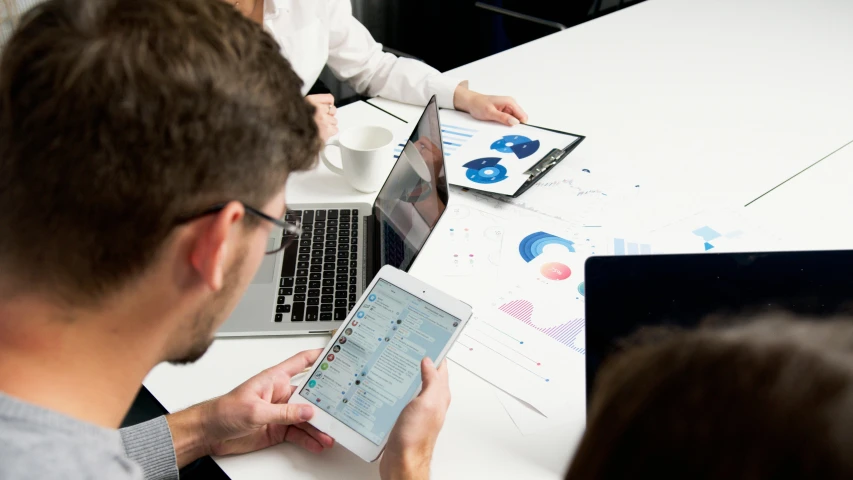 a group of people sitting around a table with laptops, pexels contest winner, analytical art, digital ui, very clear picture, lachlan bailey, business surrounding