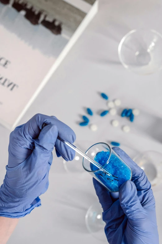 a person in blue gloves holding a glass filled with blue liquid, taking mind altering drugs, with book of science, cryogenic pods, thumbnail