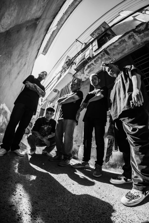 a group of people standing next to each other, a black and white photo, by Altichiero, rap metal, shady alleys, epk, lowriders