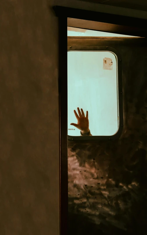 a person that is looking out of a window, by Elsa Bleda, pexels, caravan, waving hands, about to enter doorframe, passengers