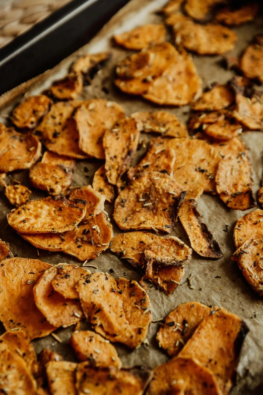 baked sweet potato chips on a baking sheet, renaissance, shot with sony alpha, herbs, contemplating, exploitable image