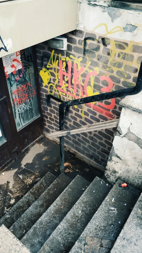 a man riding a skateboard down a flight of stairs, an album cover, inspired by Elsa Bleda, unsplash, graffiti, photo of poor condition, a ghetto in germany, trending on vsco, sewer pipe entrance