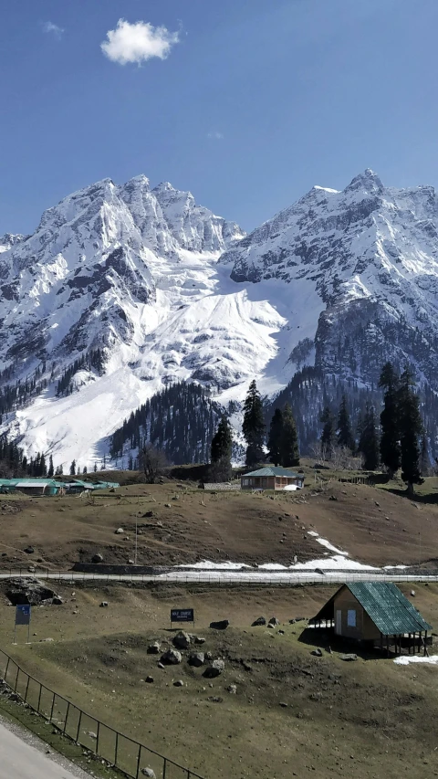 a large mountain covered in snow next to a road, hurufiyya, white marble buildings, mogul khan, 8 k hi - res, camp