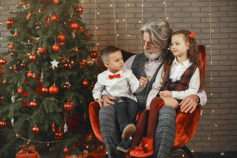 a man and two children sitting in front of a christmas tree, a photo, pexels, incoherents, gray haired, tartan garment, maxim shirkov, red brown and grey color scheme