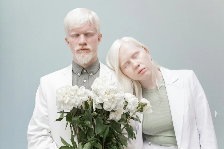 a man standing next to a woman holding a bouquet of flowers, an album cover, by Matija Jama, albino white pale skin, silver long hair, ignant, scandinavian
