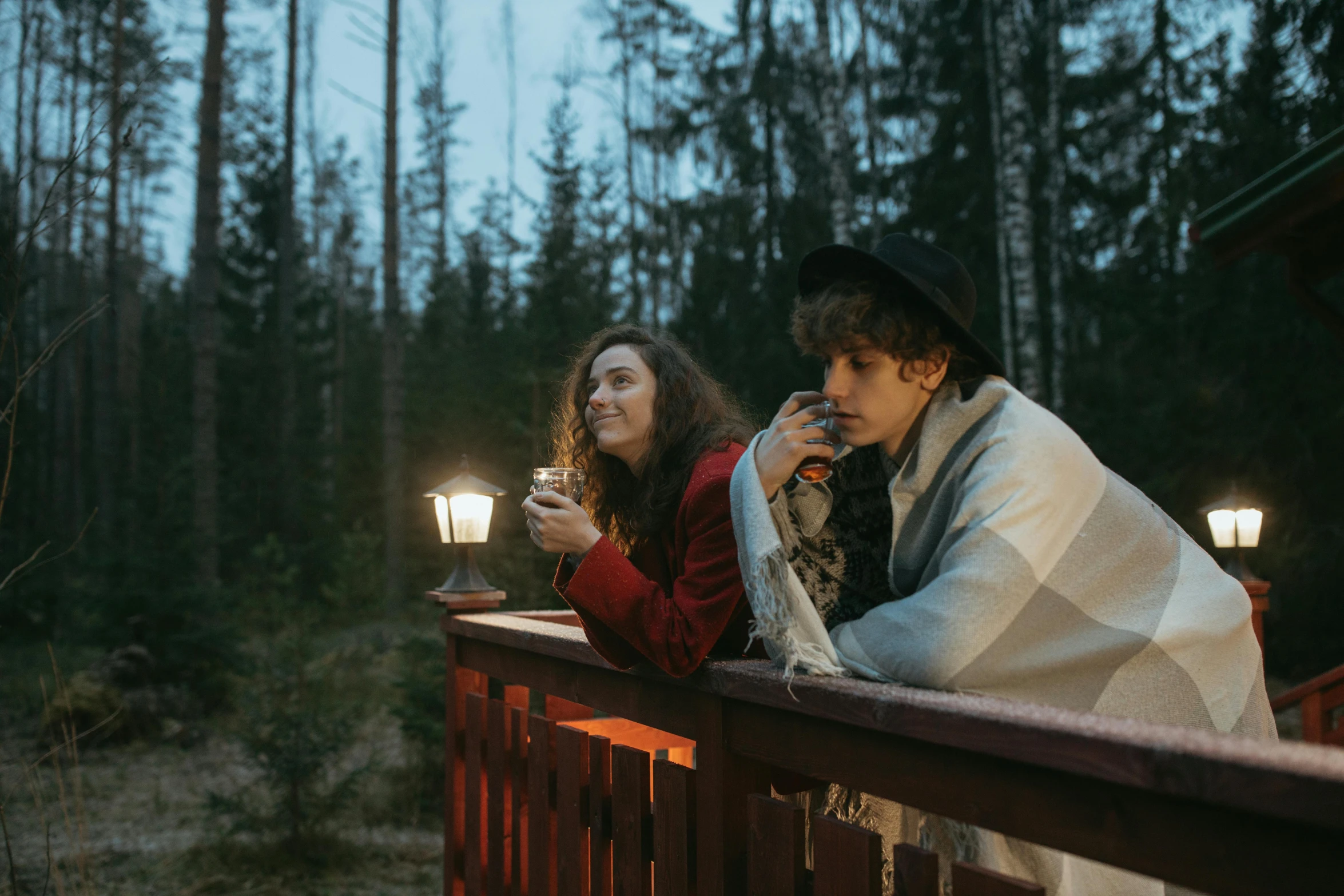 a group of people standing on top of a wooden deck, a portrait, by Jaakko Mattila, pexels contest winner, cozy candlelight, forest picnic, romantic couple, movie still of a tired