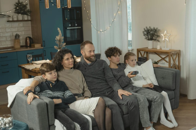 a family sitting on a couch in a living room, pexels, kramskoi 4 k, avatar image, holiday season, casually dressed