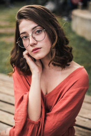 a woman wearing glasses sitting on a wooden bench, pexels contest winner, renaissance, portrait sophie mudd, small square glasses, high detailed), anna nikonova aka newmilky