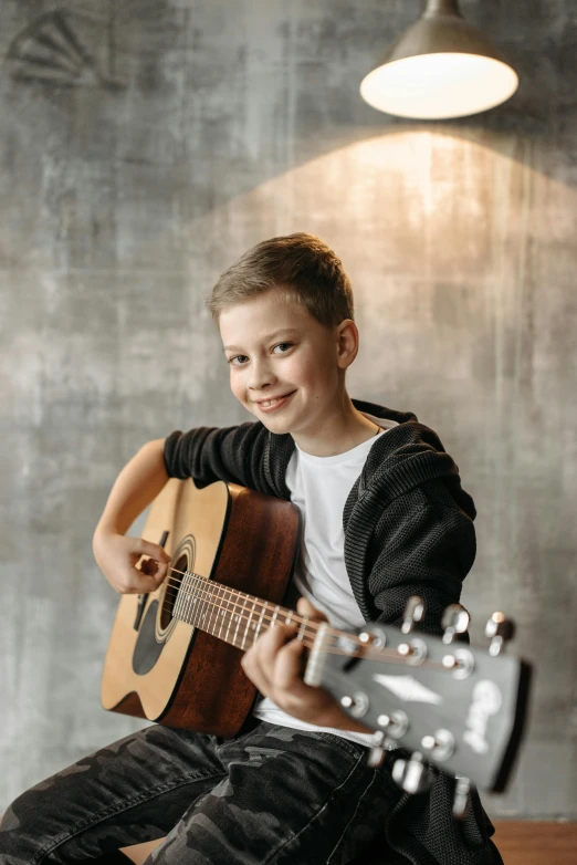 a young boy is playing an acoustic guitar, an album cover, pexels contest winner, looking confident, 15081959 21121991 01012000 4k, portrait photo of a backdrop, kids