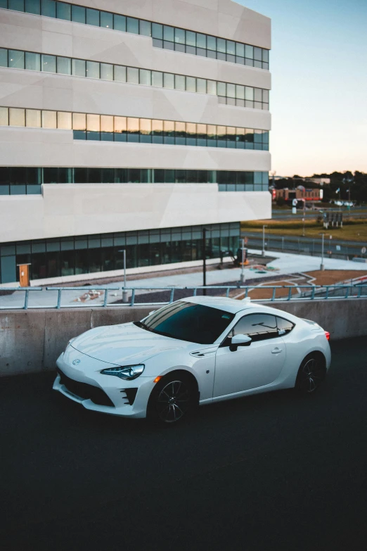 a white sports car parked in front of a building, by Alexander Robertson, unsplash contest winner, renaissance, toyota supra, square, concerned, [ cinematic