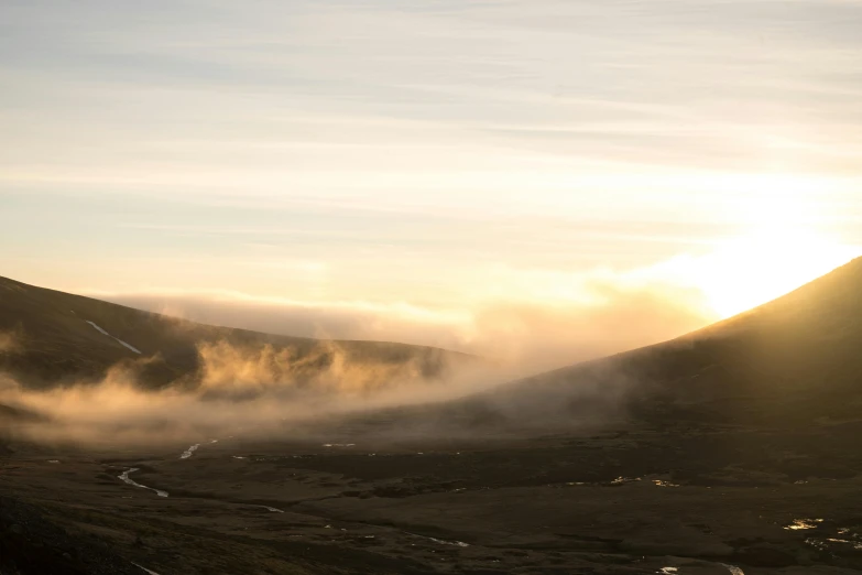 a person flying a kite on top of a mountain, by Hallsteinn Sigurðsson, pexels contest winner, hurufiyya, foggy sunset, geysers of steam, sunset panorama, brown