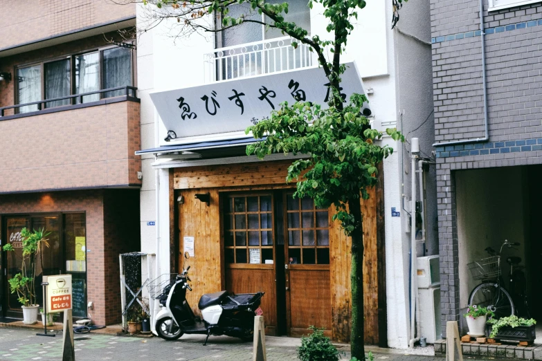 a motor scooter parked in front of a building, by Sengai, unsplash, shin hanga, restaurant!!, 千 葉 雄 大, ryohji hase, shop front