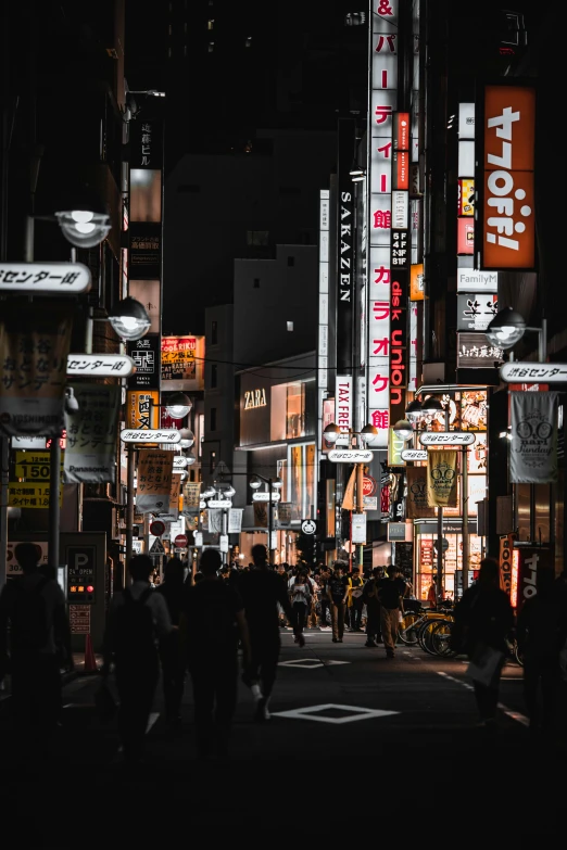 a group of people walking down a street at night, inspired by Kanō Hōgai, pexels contest winner, lots of signs and shops, ethnicity : japanese, street signs, modern city street