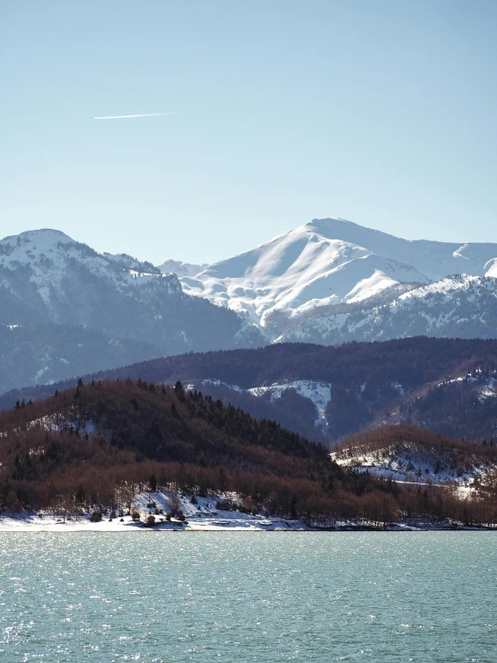 a large body of water with mountains in the background, a photo, inspired by Carlo Randanini, pexels contest winner, romanticism, (3 are winter, alpes, high picture quality, today\'s featured photograph 4k