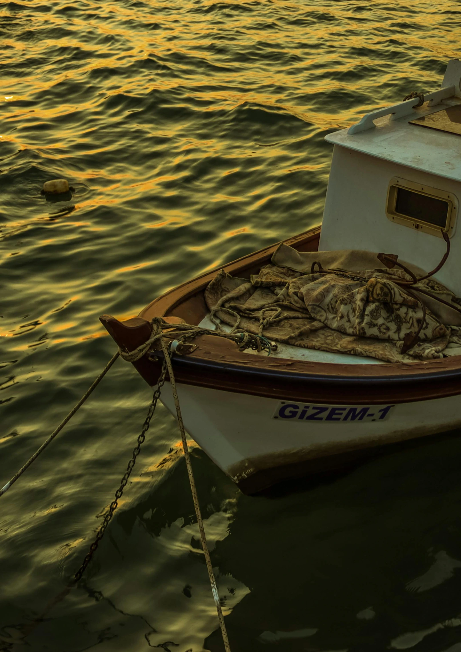 a small boat sitting on top of a body of water, inspired by Elsa Bleda, pexels contest winner, tonalism, mediterranean fisher village, crab, shades of gold display naturally, greece