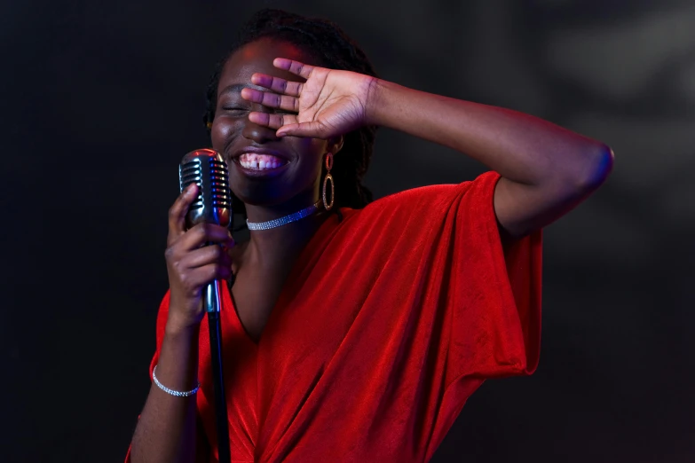 a woman in a red shirt holding a microphone, an album cover, pexels, happening, dark skinned, having fun. vibrant, 15081959 21121991 01012000 4k, thumbnail