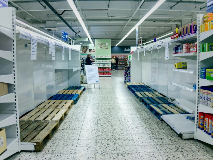 a row of empty shelves in a grocery store, an album cover, inspired by Thomas Struth, unsplash, hyperrealism, britain, collapsed floors, aisles of aquariums, full pallet image