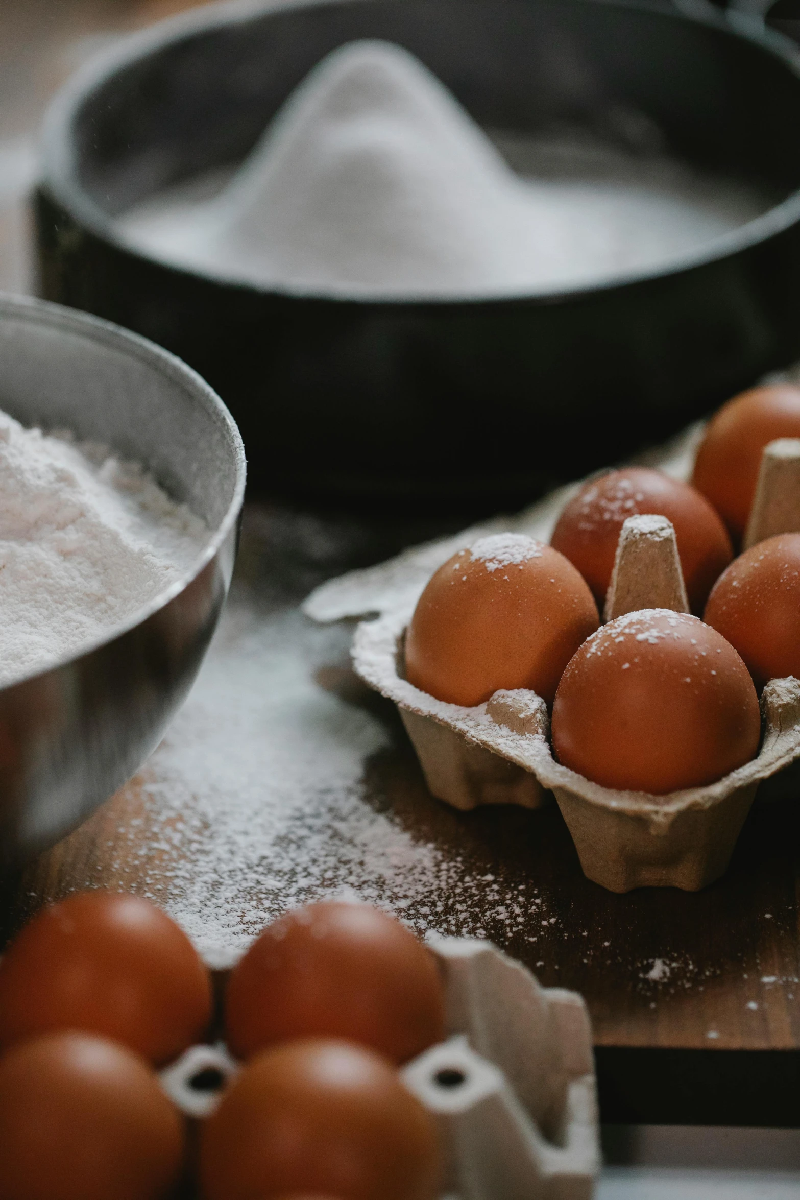 a bunch of eggs sitting on top of a wooden table, baking a cake, paul barson, pots and pans, up close