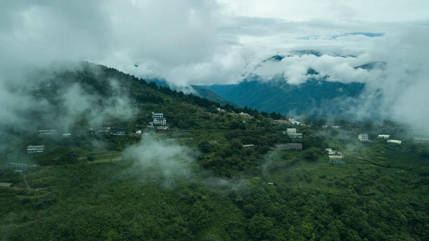 an aerial view of a village in the mountains, pexels contest winner, assamese aesthetic, covered in clouds, college, smoldering