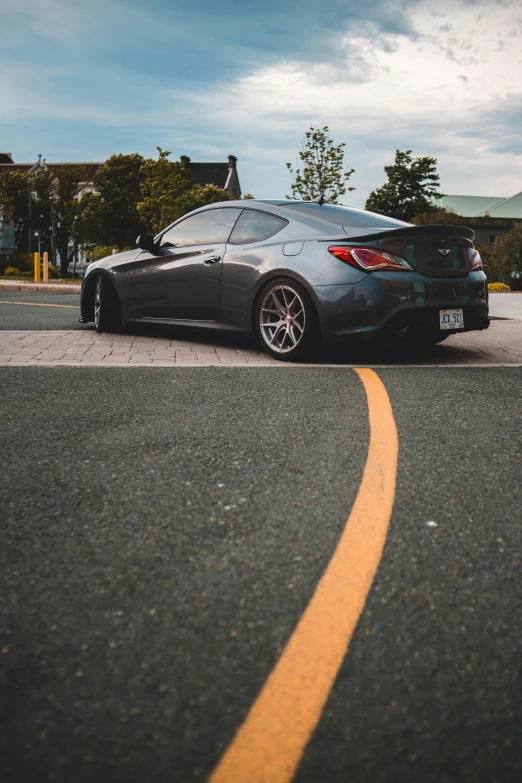 a car parked on the side of the road, inspired by An Gyeon, pexels contest winner, on a street race track, on a sidewalk of vancouver, thick tail, forward facing angle