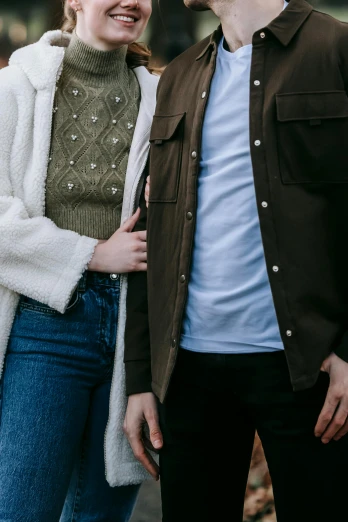 a man and a woman standing next to each other, trending on pexels, cardigan, aesthetic details, promo image, center of image