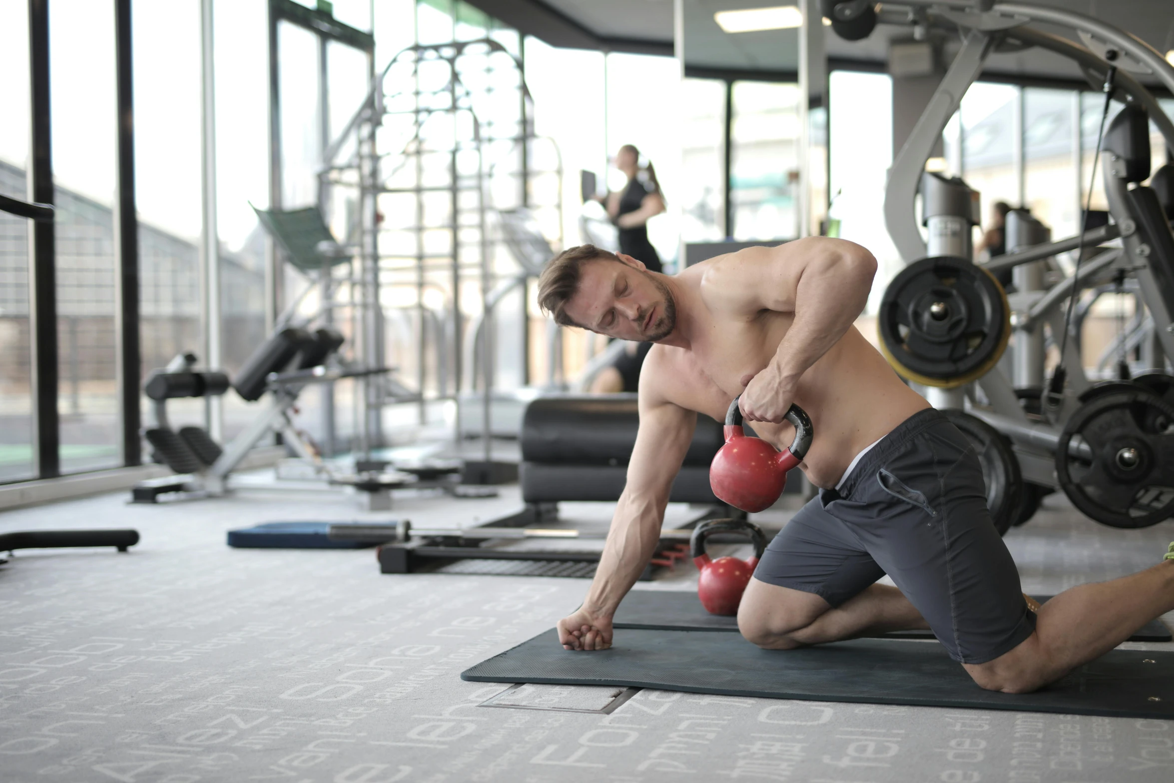 a man working out with a kettlebell in a gym, by Sam Charles, pexels contest winner, hurufiyya, manly, background a gym, 6 pack, lachlan bailey