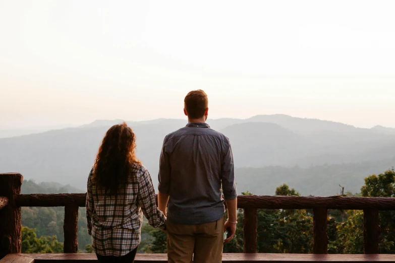 a man and a woman standing on top of a wooden bench, pexels contest winner, lush vista, profile image, looking outside, day setting