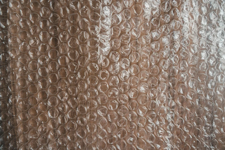 a close up of a piece of bubble wrap, by Siona Shimshi, plasticien, brown cloak, vintage - w 1 0 2 4, translucent orbs, textured base ; product photos