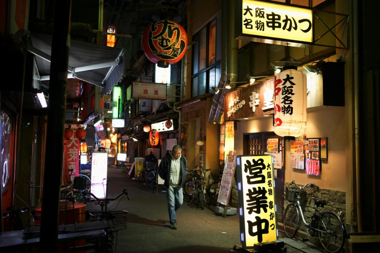 a man walking down a street at night, a photo, pexels contest winner, ukiyo-e, lots of signs and shops, dezeen, shady alleys, exterior shot
