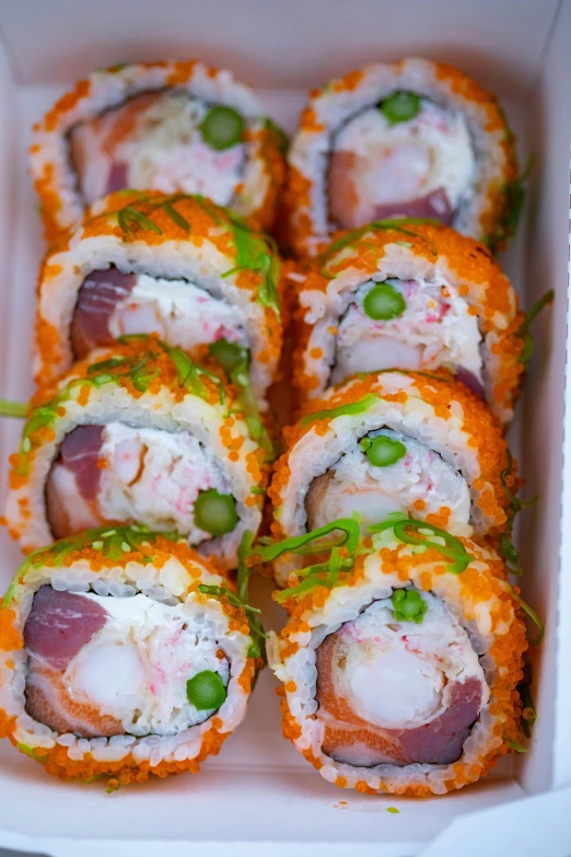 a box filled with different types of sushi, inspired by Maki Haku, tropical reef, upclose, 6 pack, white and orange