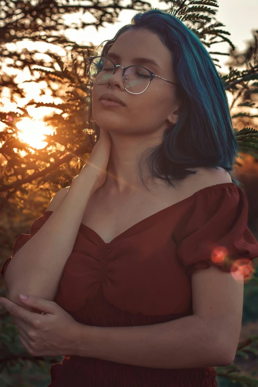 a woman with blue hair wearing glasses and a red dress, inspired by Elsa Bleda, pexels contest winner, aestheticism, ((sunset)), infp young woman, soft vintage glow, bare shoulders