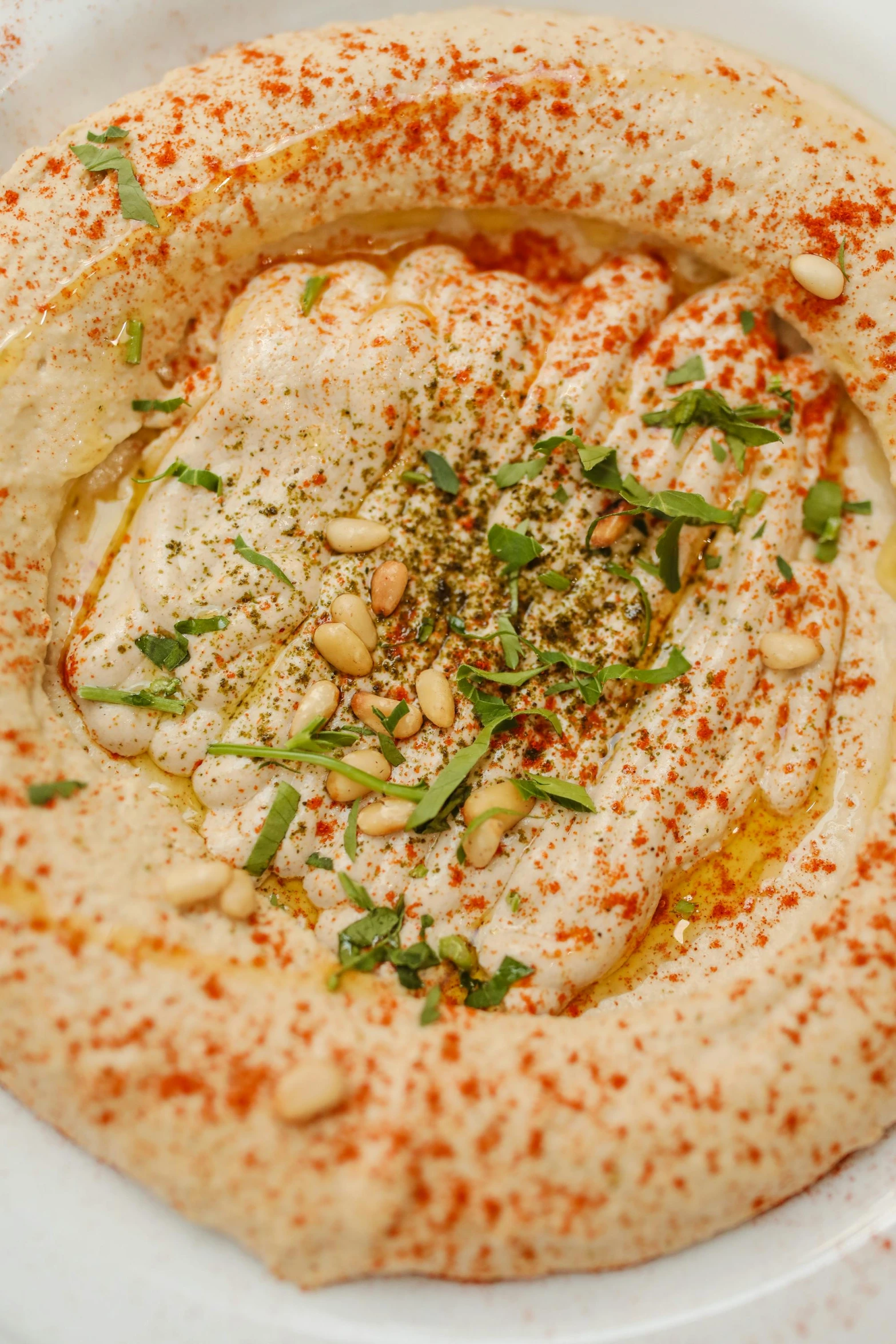 a white plate topped with hummus and herbs, by Emanuel Witz, inside a cavernous stomach, hasbulla, beige, sheikh