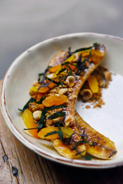 a close up of a plate of food on a table, inspired by Richmond Barthé, banana, bones, orange, charred