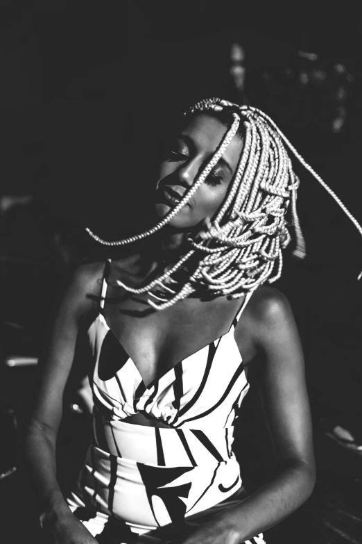 a black and white photo of a woman with dreadlocks, a black and white photo, unsplash, afrofuturism, white dress!! of silver hair, playboi carti, vocalist, beads