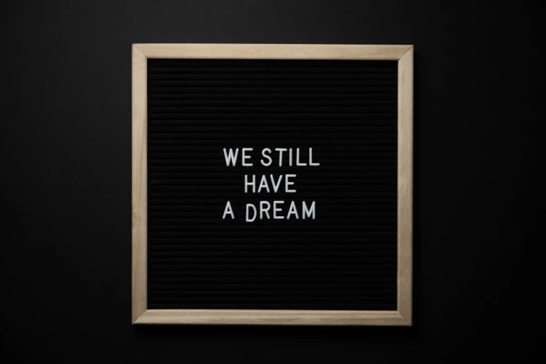 a letter board with we still have a dream written on it, dreamy and ethereal and dark, profile image, 3 2 x 3 2, marketing