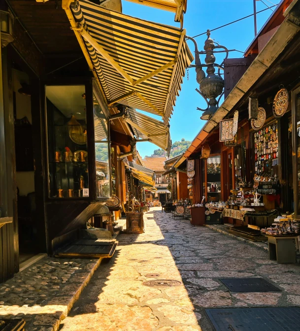 a narrow cobblestone street lined with shops, a portrait, peaked wooden roofs, bosnian, warm sunshine, square